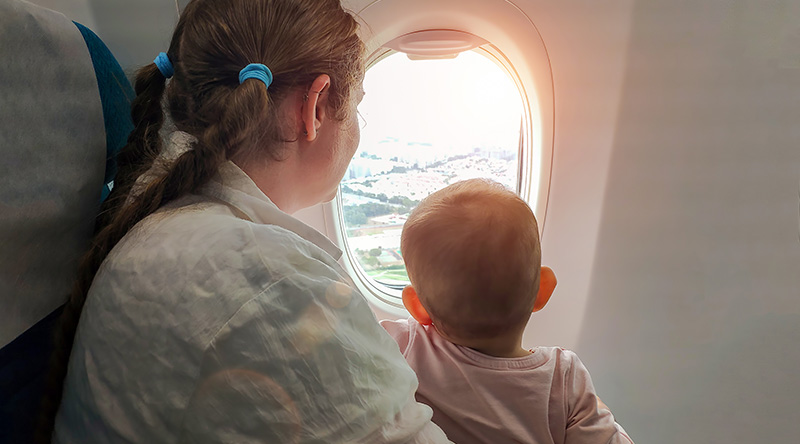 Mom-with-a-small-baby-in-her-arms-flying-on-the-plane
