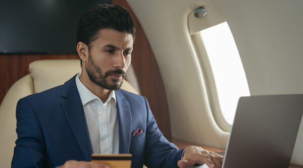 businessman-checking-at-his-laptop-on-the-plane